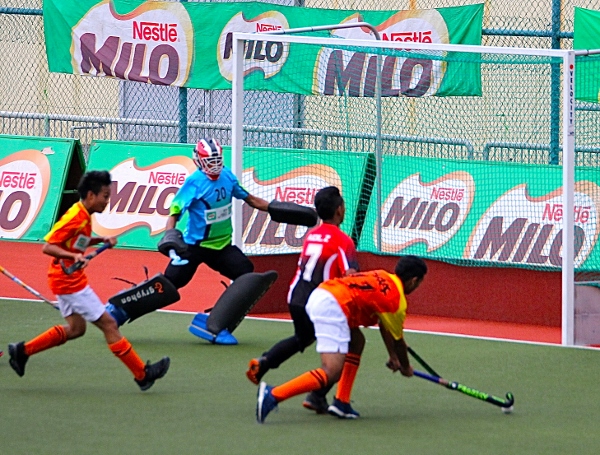 Olak-orange-and-Nur-Insafi-players-tussle-for-the-ball-in-a-goalmouth-action.