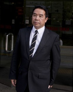 Hairdresser-turned-football tycoon, Birmingham City owner Carson Yeung leaves the Wanchai district court in Hong Kong on October 28, 2013. Yeung has insisted he amassed his fortune through legitimate means, including high-end hair salons, as he testified in his 93 million USD money-laundering trial in Hong Kong. AFP PHOTO / ALEX OGLE