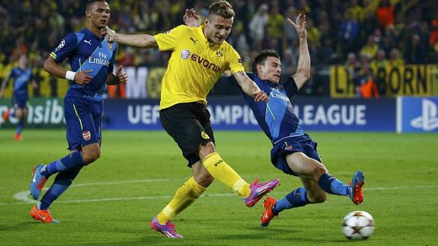 Borussia Dortmund's Ciro Immobile scores a goal past Arsenal's Laurent Koscielny (right) during their Champions League group D soccer match in Dortmund on Sept 16, 2014. Borussia Dortmund's Ciro Immobile scores a goal past Arsenal's Laurent Koscielny (right) during their Champions League group D soccer match in Dortmund on Sept 16, 2014.