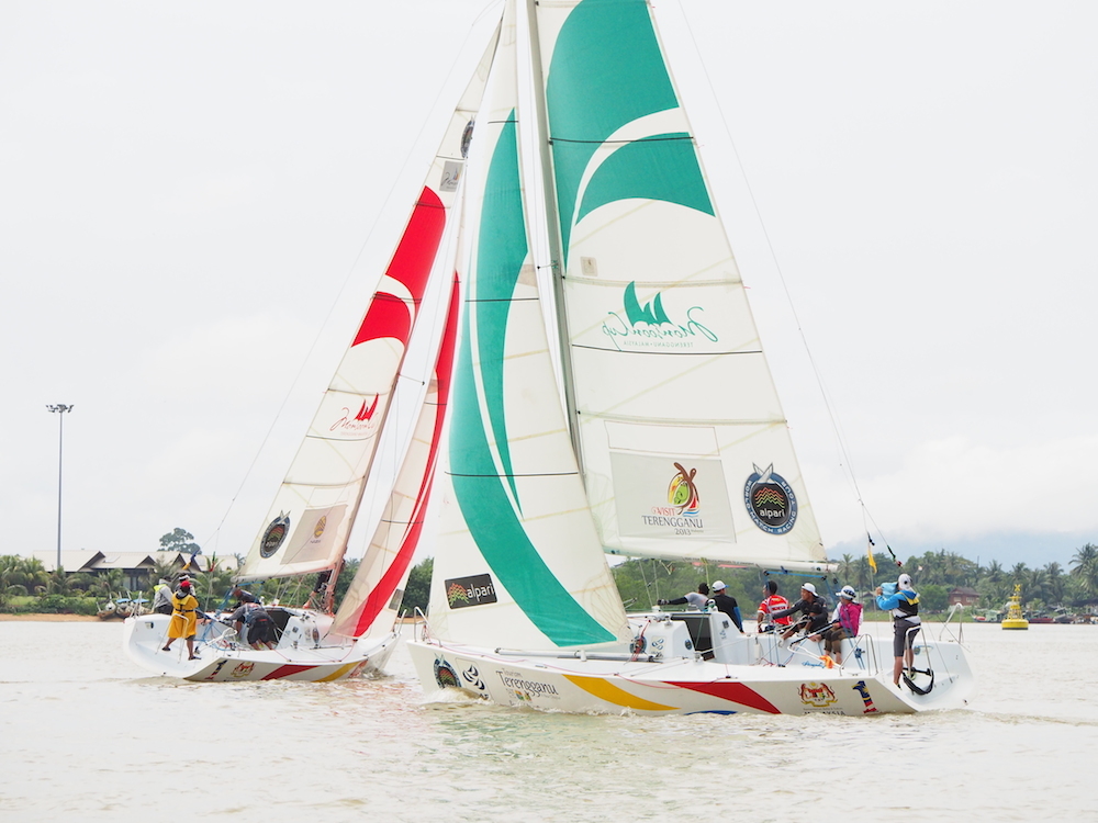 Jeremy Koo's Sime Darby Foundation/1Malaysia Match Racing Team (left) in action against Nurul Elia Anuar's ReMix Team during the final of LLM 2014 Pulau Duyong.