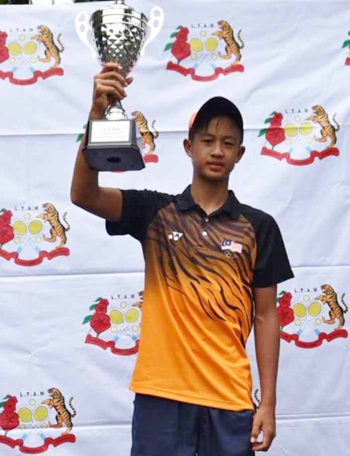 Christian with the champion trophy in Kelantan.