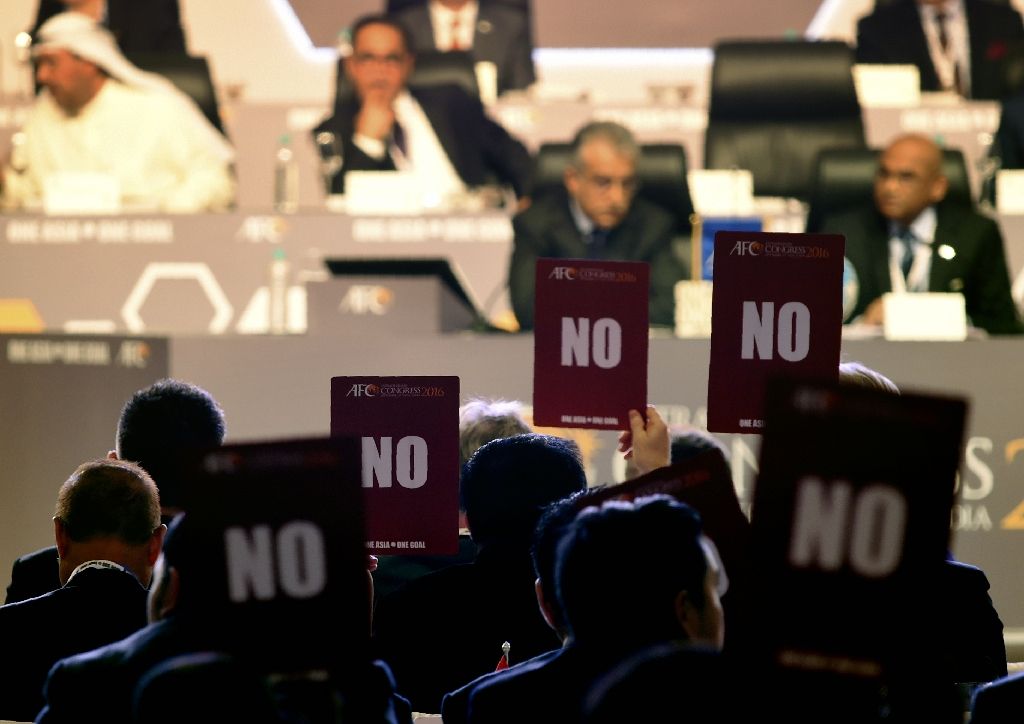 AFC members hold up 'NO' voting cards during the AFC Extraordinary Congress in Goa. AFP Photo.