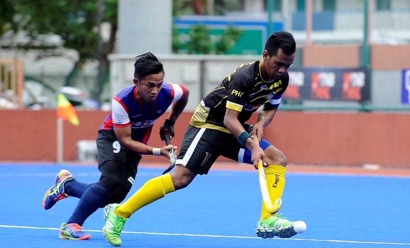 Pemain THT, Faizal Shaari cuba melepasi kawalan pemain TNB Shahril Izwan dalam aksi separuh akhir yang dimenangi TNB 3-2